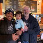 Baynody Méndez Jiménez holds his son as his father-in-law, Cliff Goodman, poses with them for a portrait at Vashon Brewing Community Pub last month. (Kevin Opsahl/Staff Photo)
