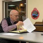 Vashon Health Care District commissioner Eric Pryne looks over his notes during a meeting at Vashon Presbyterian Church on Wednesday, Feb. 19. (Kevin Opsahl/Staff Photo)