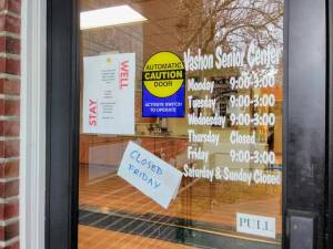 A note on the door of the Vashon Senior Center says the facility will be closed on Friday, March 6, but the executive director announced on Thursday it is in fact closed for the foreseeable future due to concerns of COVID-19. (Paul Rowley/Staff Photo)