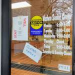 A note on the door of the Vashon Senior Center says the facility will be closed on Friday, March 6, but the executive director announced on Thursday it is in fact closed for the foreseeable future due to concerns of COVID-19. (Paul Rowley/Staff Photo)