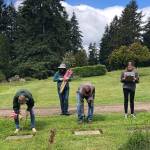 The family team of George, Kelly, Stephen and Kora Murphy helped place flags on the graves of veterans at Vashon Cemetary on Saturday (Tom Hughes Photo).