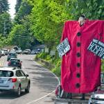 Island theater artist Mik Kuhlman created a performance aimed at out-of-towners last weekend. She told The Beachcomber she hopes to repeat her solo show, wearing a mask and giant clock, at other times throughout the summer (Jeff Dunnicliff Photo).