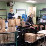 One key partner to the Emergency Operations Center for this emergency has been the Vashon Maury Community Food Bank. These photos show a few of the dozens of Food Bank volunteers assembling bags of groceries for distribution to members of the community who rely on this nutrition. Demand for support from the Food Bank has steadily increased in the nearly three months since the emergency began (Michelle Bates Photos).