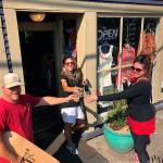 (From left to right) Dustin Landry, Diana Anderson and Tesse Crocker toast the future of Vashon Boards and Luna Bellas Womens Consignment Boutique (Courtesy Photo).