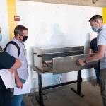 UW mechanical engineering doctoral student Ben Sullivan (right) shows first responders how the decontamination box for N95 masks works (Andy Freeberg Photo).