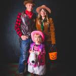 Chamber of Commerce Vice President Melissa Schafer with her husband Nathan Schafer and daughter Isadora Schafer, in 2018  following their long tradition of having their photograph taken on Halloween by local photographer Marla Smith. This year, Schafer said she and her daughter and husband will once again pose for a photograph by Smith, who is offering sessions both at Mukai Farm and Gardens (for those who want to be photographed in costume) and Langely Fine Gardens (for those who want to be photographed in a pumpkin patch) (Marla Smith Photography).