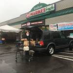 IGA assistant manager Byron Cox loads groceries into islander Michael Schosboeks car on a rainy November day. The stores online ordering tool, rosieapp.com, allows islanders to easily shop at home and pick up their groceries curbside within hours. Store owner Shawn Hoffman said he hoped more islanders will consider using the platform, as the number of people allowed in grocery stores is now limited to 25% of occupancy (Elizabeth Shepherd Photo).