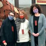 Priscilla Schleigh, Julie Speidel and Allison Reid outside of Giraffe, modeling necklaces made by Speidel to support Giraffe and benefit Vashon Center for the Arts (Natasha Blanchette Photo).