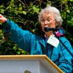 Mary Matsuda Gruenewald, speaking at the 2013 Washington Trust for Historic Preservation, This Place Matters rally outside the Mukai Farm and Garden, which had been fenced off by those who then controlled the property. In a passionate speech, Matsuda Gruenewald drew cheers from the audience with her upraised hand (Nick Anderson Photo).