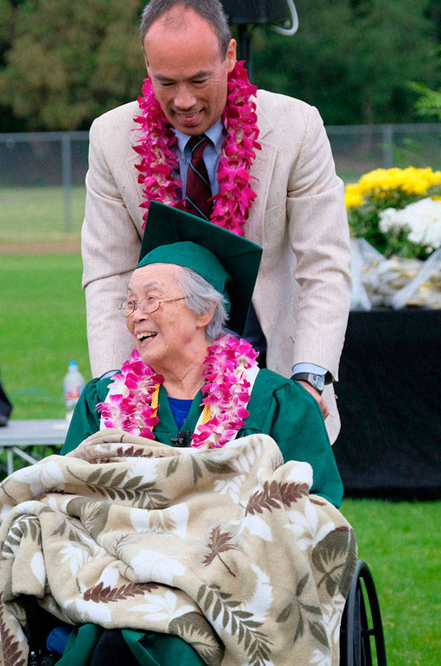 Mary Matsuda Gruenewald, with her son Ray Gruenewald, at Vashon High Schools graduation ceremony in 2017. That year, the school awarded Mary the high school diploma she would have received 75 years earlier, had she not been part of the mass evacuation and internment of people of Japanese ancestry on the West Coast (Kent Phelen Photo).