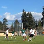 Senior Zach Van Dusen faces Charles Wright, as Jakob Heuschert stands by (Lila Cohen Photo).