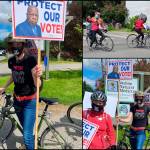 Molly Matter, with other activists on Vashon, holds a sign aloft, promoting legislation to protect voting rights and end the filibuster. Vashons votercade  a group described by one participant as small but mighty, included both cars and bicycles, with drivers raising noise and awareness about the legislation now before Congress (Jen Williams Photos).