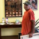 Jack Chevalier, a longtime islander whose artwork was included in many museum exhibitions and collections, hung his work in 2017 for a local show at Puget Sound Cooperative Credit Union (Courtesy Photo).
