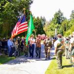 The Color Guard, led by Commander John Burke, retires the colors after the Memorial Day ceremony at Vashon Cemetery on Monday (Paul Rowley Photo).