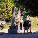 The War Memorial behind the days speakers at Vashon Cemetary has stood for a century, commemorating those who have died in conflicts dating back to 1861 (Paul Rowley Photo).
