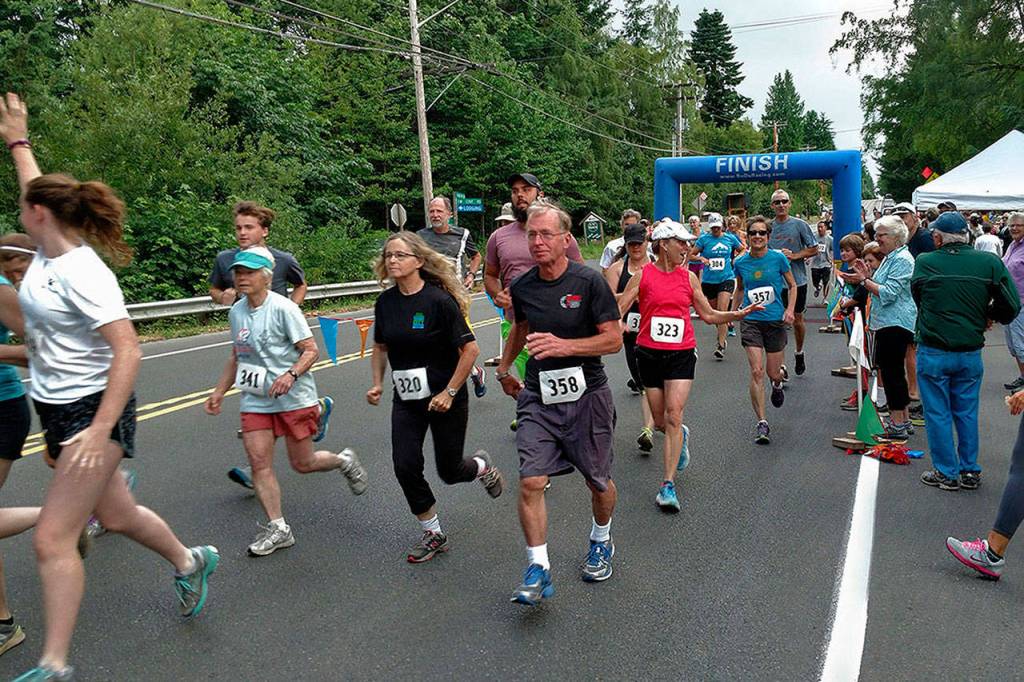 Runners cross the finish line at a past Bill Burby race (Mike Kirk Photo).