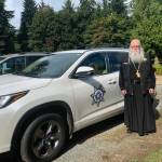 Courtesy Photo
Abbot Tryphon, of Vashons All-Merciful Savior Monastery, has long served as an unpaid fire and police chaplain on the island. In this photo, he is shown on the monasterys grounds, standing by the vehicle he now uses to respond to calls.