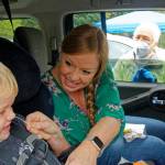 (Photo by Rick Wallace, with permission of parent and child) Teacher Adrian Preston, tested on Tuesday, Sept. 27, also helped her son, three-year-old Easton, with his test swab. Teacher Adrian Preston was getting tested today and she then helped her son, three-year-old Easton, with the test swab. Medical Reserve Corps volunteer Wendy Noble looked on to make sure it would be a good test sample.