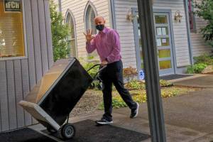 Courtesy Photo
As part of preparations to open Vashons new clinic for vaccine booster shots, Tyler Young, the owner of Vashon Pharmacy, rolled in a refrigerator that will be used to keep vaccines at the correct temperature. The appointment-only mass booster shot vaccine clinic is located at the Methodist Church, just south of the islands business district.