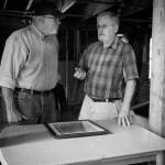 Terry Donnelly Photo
Hal Green and Bruce Haulman at the Paige/Green, Triplebrook Farm Barn, the oldest barn on Vashon. They are discussing the 2007 restoration Molly and Hal Green oversaw using dimensional fir lumber cut to match the original timbers, and the hand-cut steel nails they had made to match the original nails.