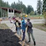 (Courtesy Photo)	Second-graders at Chautauqua Elementary School take a break from their work in building a native pollinator garden outside their classroom window.