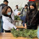 (Courtesy Photo) Nidia Sahagun, Vashon Island School Districts family engagement coordinator, works with students in VHSs LatinX student club to construct wreaths. The project was undertaken with Valeria Martinez Espinoza, from Vashon Nature Center.