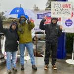 (Jenna Riggs Photo) Rain gear, umbrellas and camaraderie were all on display at Indivisible Vashons action marking January 6.