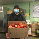 (Elizabeth Shepherd Photo) Paxtin Spencer, co-manager of the Vashon Food Bank Warehouse, at work last week.