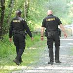 (Staff Photo) King County Sheriffs Deputies Seth Moore and Glen Brannon in Island Center Forest, in 2018.