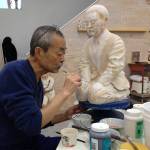 (Photo Courtesy of Vicky Takamori) Akai Takamori, in his studio in 2016, painting his work of art, Apology.
