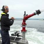 South King Fires Merrick McGinnis demonstrates the water canon on fire boat Zenith on May 26. (Olivia Sullivan/the Mirror)