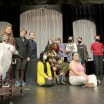 (Andy James Photo) The cast of A Spirited Manor, posing with the shows spooky mascot, Yulia (in lace dress) includes (back row, left to right) Japhy Tsaitsenhoven, Bishop Townsend, Nathan Campbell, Isaac Huff, Chloe Bay, Harper Hobson, El Otto, Chris Wechkin, Richard Barrett-Wood, and (front row, left to right) Phoebe Ray, Raena Joyce, Ari Officer. Not pictured: Ian Ingalls.