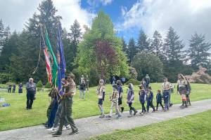 (Tom Hughes Photo) A color guard solemnly began a celebration of Memorial Day at Vashon Cemetery.