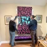(Courtesy Photo) Bob Katica and Walker Dodson install Lets Dance, a wood carving by Brian Fisher that was included in Vashon Heritage Museums award-winning exhibition, In and Out: Being LGBTQ on Vashon. The artwork is included in the museums online auction, running June 11 to 25.