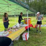 (Lisa Cyra Photo) Dashell Adams, 22, from Bellingham, got aid from Casey and Kathleen Lawrence between laps in the 50k race.