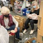 (Dennis Clouse Photo) Windermere Vashon brokers Nancy Davidson (left) and Denise Katz (right) volunteer at Grannys Attic on Friday, June 10.