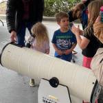Kids looking through telescope at Edwin E. Ritchie Observatory in Bainbridge Island, WA. Photo courtesy of Battle Point Astronomical Association.