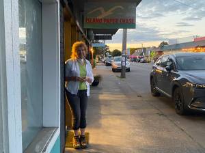 Alice Larson stands outside of Island Paper Chase, which closes its doors at the end of the month. (Tom Hughes Photo)