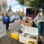 The day before Thanksgiving, a group of volunteers helped stack food high on food tables stocked by a Vashon nonprofit, One in the Spirit Ministries (Elizabeth Shepherd Photo).