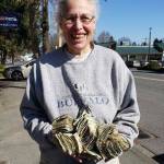 Hilary Emmer, on March 18, 2020, when she received the first large donation to Vashons Virus Rent Fund  a bag filled with $1 dollar bills (Courtesy Photo).