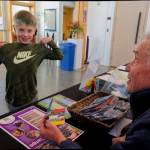 Local artist Bruce Morser greets Declan Baer at a recent Vashon Center for the Arts event for families (Rick Wallace Photo).