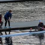 BBRC Coach Richard Parr and eighth-grader Briar Guenther stood on the dock, while Grant Gonter launched his U17 Single at Brentwood (Laird Gonter Photo).