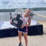 Former Burton Beach Rower, Kate Davis, holds the trophy as the University of Virginia team celebrates their ACC championship (Becca Davis Photo).