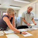 Melody Snyder and Seth Zuckerman sort out the winners among applicants in Water District 19s drawing for new water shares on Vashon (Elizabeth Shepherd Photo).