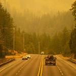 An emergency fire vehicle heads past a barricade and towards Index as numerous agencies attempt to contain the Bolt Creek Fire on Saturday, Sep. 10, 2022, on U.S. Highway 2 near Index, Washington. (Ryan Berry / The Herald)