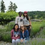 Cathy MacNeal, lower right, poses for a photo among the lavender with the 2023 summertime interns (clockwise from lower left) Jeyli Castañon, Victoire Soumano and Ava Lee on June 13 (Olivia Sullivan Photo).