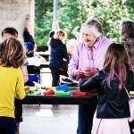 Islander Yvonne Kuperberg, who participated in a pen pal project pairing third-graders with island seniors, was all smiles last week as she and students participated in a crafting project (Dawn Stief Photo).