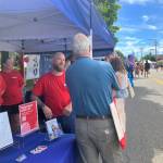 At Vashons Strawberry Festival, staff members of the Seattle Indian Health Board, including islander Brian Springfield, answered questions from islanders who stopped by the organizations booth (Elizabeth Shepherd Photo).