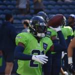 Seahawks first-round pick Devon Witherspoon throws a football to a coach during warm-ups. (Photos by Ben Ray / Sound Publishing)