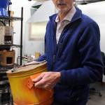 Burn Design Lab Executive Director Paul Means holds a stove that was made by hand; an impressive feat of manual engineering, but one thats difficult to produce at scale, Means said (Photo by Alex Bruell).
